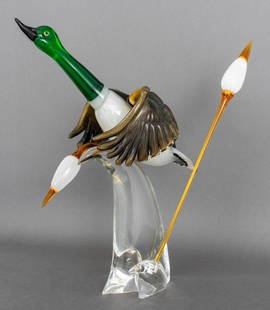 Oscar Zanetti Murano Glass Mallard Duck Sculpture: Oscar Zanetti (Italian, b. 1961) Murano Art Glass Sculpture of a Mallard Duck in Flight, comprised of a duck on a clear base issuing two cattails, with Zanetti label to base, and signed "Zanetti / Osc