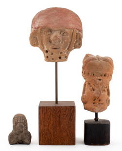 Pre-Columbian Figural Pottery Sculptures, 3: Group of Three Ancient Pre-Columbian Figural Pottery Sculptures, comprising: one black clay deity figure, and two masque head sculptures wearing headdresses and earrings, on wood bases. Tallest