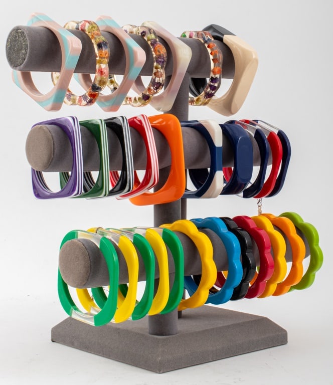 Collection of Resin and Lucite Bracelets, 29: Collection of 29 Resin and Lucite Bracelets, comprising: one orange rounded square, one square half black half cream, one square navy blue resin, one square tricolor pink, white, and clear lucite brac