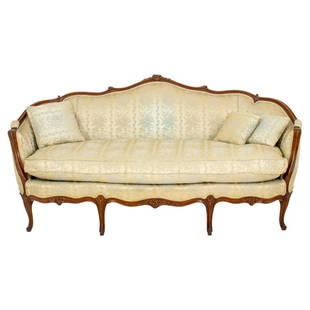 Rococo Louis XV Style Damask Upholstered Sofa: French Louis XV Rococo Style Sofa, the fruitwood scrolling back rest with floral carvings, downswept arms, and shaped seat with one above cabriole legs, upholstered in beige silky damask. 34.5" H x 74