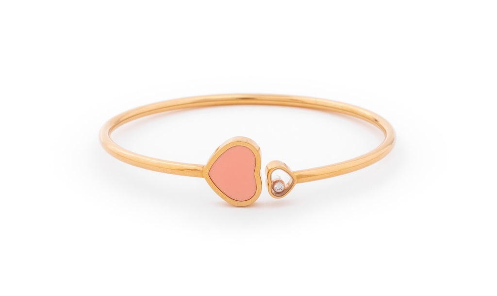 Chopard Happy Hearts 18K Diamond Pink Stone Bangle: Chopard Happy Hearts Collection Bangle, fabricated in 18K rose gold, featuring one floating diamond weighing approx. 0.05 carat, further decorated with one pink heart shaped cabochon, worn on wrist as