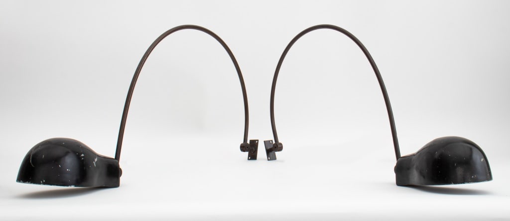 Mercer Kitchen Modern Arched Sconces, Pair: Mercer Kitchen arched sconces in black and brown enameled steel inspired by Jean Prouve (French, 1901-1984) 14" H x 24" L x 4" W Provenance: The Mercer Kitchen, Mercer Hotel, New York. Note: The Merce