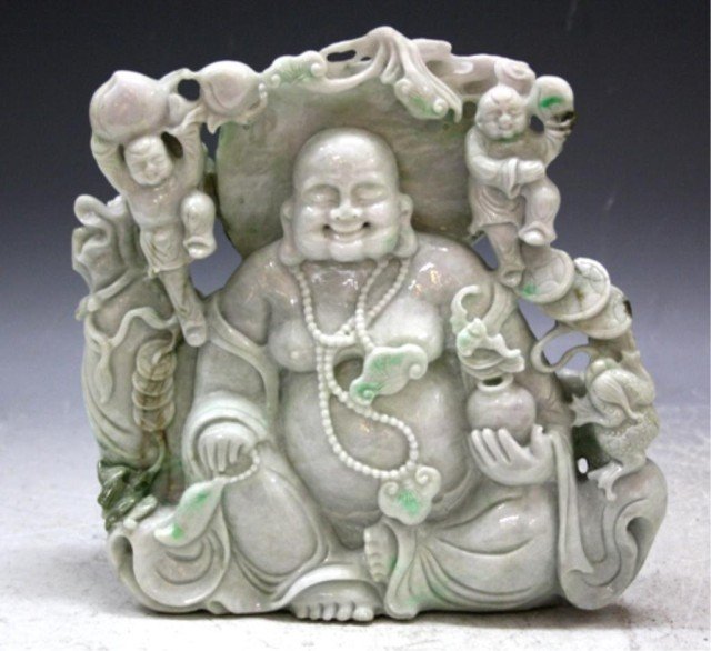 Large Jade Carving of Seated Buddha: Large jade carving of a seated Buddha surrounded by frogs, mushrooms, bats, and other figures; unmarked. Dimensions: 9"H x 9"W x 3"D