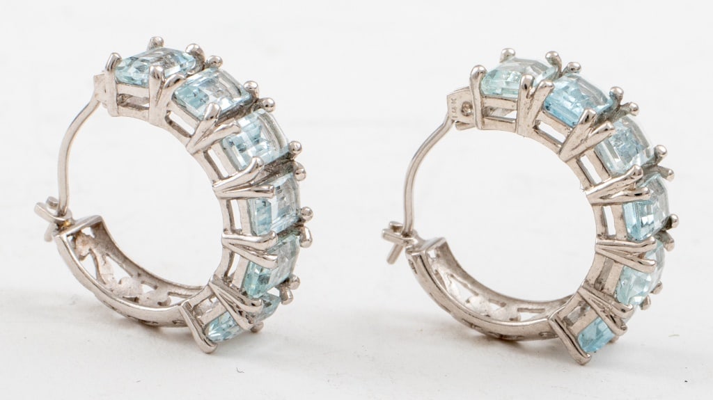 14K White Gold Aquamarine Mini Hoop Earrings: 14K White Gold Aquamarine Open Scroll Design Mini Hoop Earrings, comprised of twelve 5 x 3mm emerald-cut aquamarine stones, marked: "14K / 55 / MEXICO", 0.68"L x 0.25"W. Approx: 2.2 dwt. inclusive. Pr