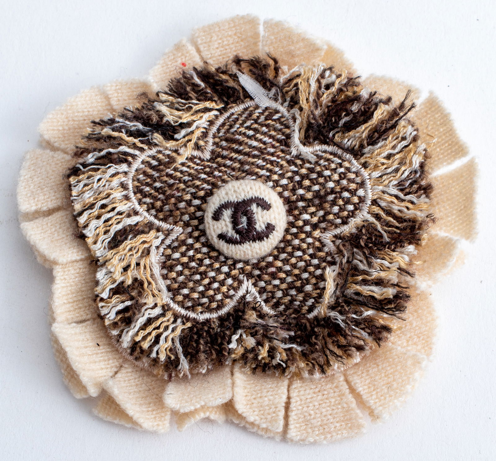 Chanel Brown Tweed Camellia Flower Form Brooch: Chanel Beige and Brown Tweed Camellia Flower Form Brooch, with embroidered signature double-C logo to center. 4" L x 3.75" W. Provenance: From a Carlton House (21 East 61st Street) Estate. Keywords: D