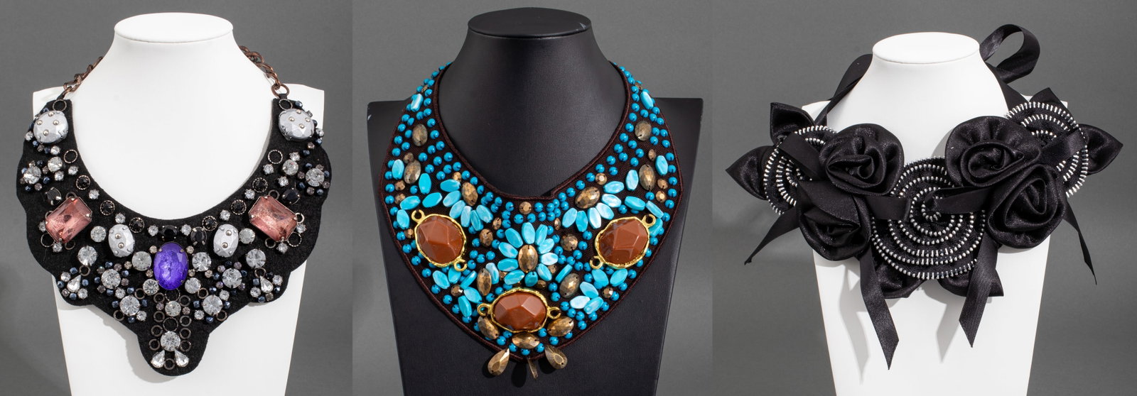 Cloth Bib Necklaces, 3: Three Cloth Bib Necklaces, comprising: black cloth with zipper teeth flower forms, black cloth with faceted rhinestones, and brown cloth with turquoise colored bead and tan cabochons. Largest: 38.5" L