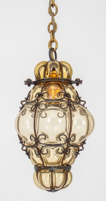 Archimede Seguso Attr. Blown Glass Pedant Lamp: Archimede Seguso Attributed Amber Blown Out Glass Pendant Lamp, circa 1960s, within a wrought iron cage with scrolling design. 23" H x 6.5" Diameter. Provenance: From a New York City Collection. Keywo