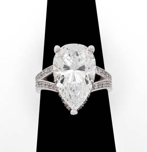 14K White Gold Pear Shaped CZ Solitaire Ring: 14K White Gold Pear Shaped Cubic Zirconia Solitaire Ring, flanked with pave CZ and eternity shank. Center pear shaped CZ approx: 16 x 9.8 mm. Marked: "14K / SWI / CZ / KOREA". Ring measures: 0.812"L