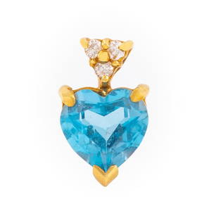 14K Yellow Gold Blue Topaz Diamond Pendant: 14K Yellow Gold Blue Topaz Diamond Pendant, brightly polished, featuring a heart shaped brilliant blue topaz, prong set weighing approx. 2.20 carats, further decorated with three prong set round