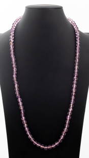 Faceted Amethyst Bead Necklace 14K Clasp: Faceted Amethyst Bead Necklace, featuring round beads approx. 8.5-9.0 mm, strung on silk cord, joined with 14K yellow gold fish hook clasp, marked: "14K", Measuring approx. 30", 44.3 dwt. Provenance: