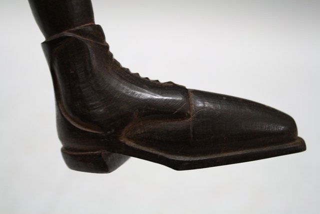 Antique Wood Shoe Shaped Walking Stick Cane: Whimsical grain wooden antique cane or walking stick with handle in the shape of a realistically carved shoe, complete with a semi-circle of nail heads in the bottom of the heel; unmarked. Approximate