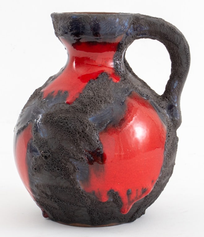Scheurich Keramik Fat Lava Pitcher: Scheurich Keramik West German "Hot Lava" Pitcher, 1960s, in red and pumice black glazes, apparently unsigned, with narrow neck and handle above a spherical body. 7.5" H x 6" Diameter. Provenance: Prop