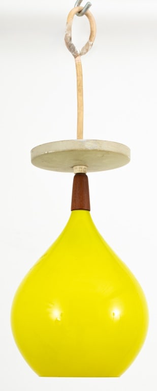 Scandinavian Modern Glass & Teak Pendant Lamp: Scandinavian Modern Yellow Glass and Teak Pendant Lamp, the tear-drop shaped light shade suspended from a teak wood fitting. 12" H x 7" Diameter. Provenance: From a New York City Collection. Keywords: