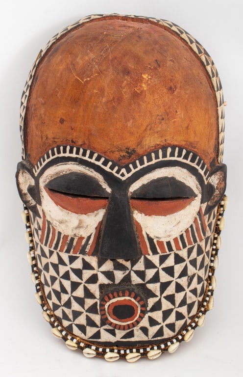 African Kuba Ngaady Mwaash Wood Mask: African Kuba Ngaady Mwaash Carved Wood Mask, geometric patterns on lower half of head, ringed with cowry shells and beads. 13" H x 8.25" W x 4.5" D. Provenance: From an Upper West Side estate located 