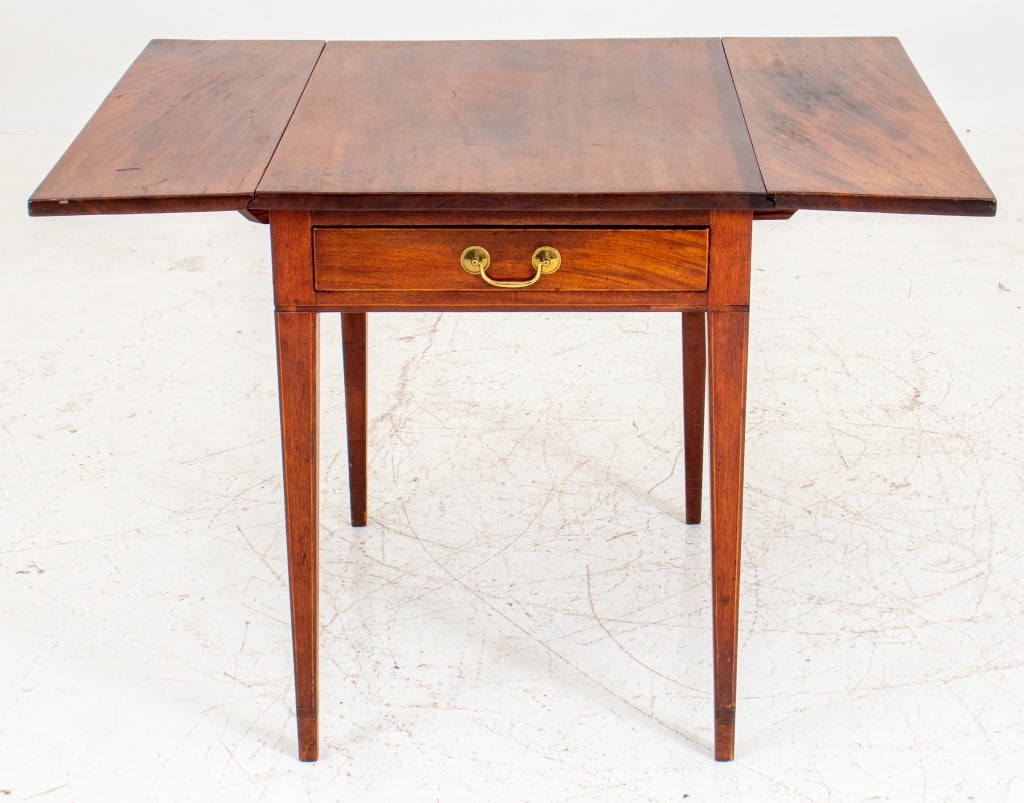 George III Mahogany Pembroke Table: George III Mahogany Pembroke Table, rectangular with two drop sides and a short drawer at one end, the legs with satinwood stringing. 28.5" H x 23" W; 41" W x 30.5" D. Provenance: From a New York City