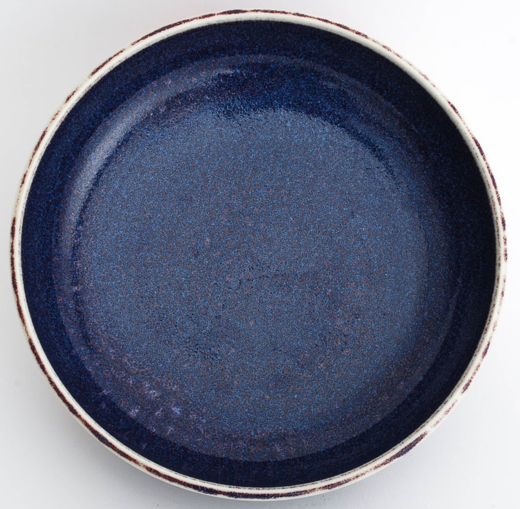 Thomas Bezanson Blue Glazed Porcelain Shallow Bowl: Brother Thomas Bezanson (Canadian, 1929-2007) Blue Glazed Porcelain Shallow Bowl, incised "Benedictine Monks / Weston Vermont" to underside. 1.75" H x 8" Diameter. Provenance: From 333 East 75th Stree