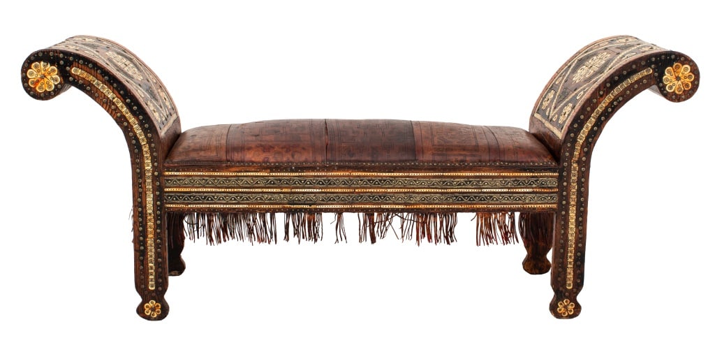 Moroccan Bone Inlaid Wood and Leather Bench: Moroccan Bone Inlaid Wood and Leather Bench, inlay arranged in floral motif, nails with floral form heads, geometric design to leather seat, with leather fringe. 30.5" H x 73" W x 17.75" D. Provenance