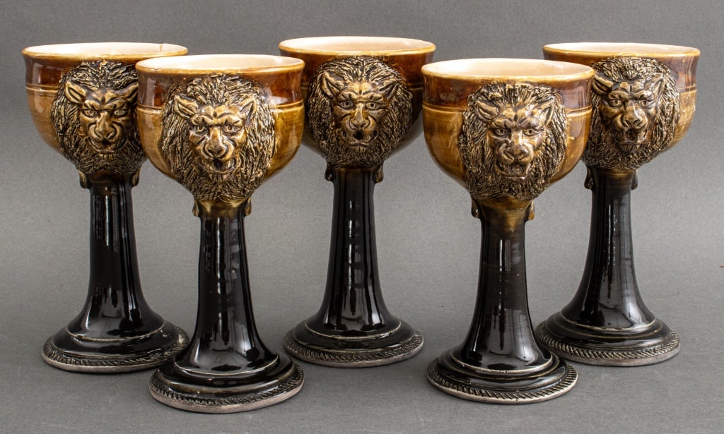 Signed American Art Pottery Lion Chalices, 5: Set of Five Jeffrey (American, XX) Art Pottery Lion Goblets, 1977, each signed and dated, each with sepia and olive glaze with two lion masques to each. 8.25" H x 4.5" Diameter. Provenance: From a New