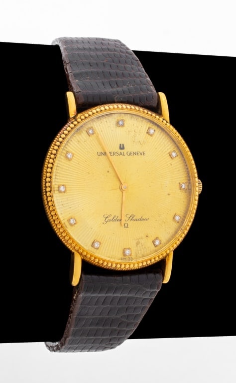 Universal Geneve 18K Diamond Golden Shadow Watch: Universal Geneve 18K Gold Diamond Golden Shadow Watch, featuring engine turned gold-tone dial with 12 prong set single cut diamonds weighing a total of approx. 0.08 carat as indexes, powered by batter