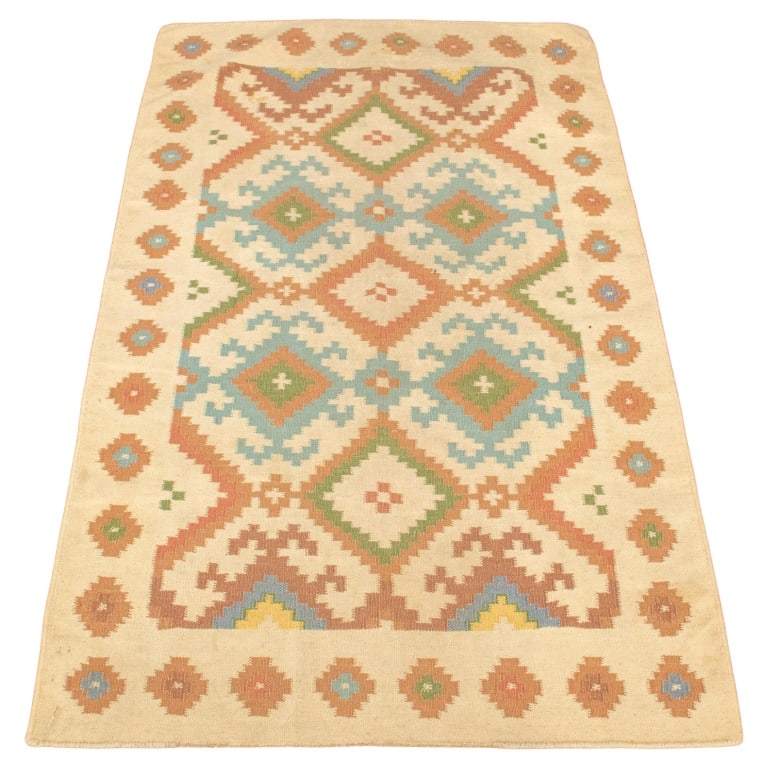 Persian Kilim Rug, 5' x 3': Persian Kilim Rug, with blue and green geometric pattern on tan ground. 5' L x 3' W. Provenance: From an East Village Estate. Keywords: Textile, Wool, Polychrome, Decorative Arts, Pastel, Muted hues, 