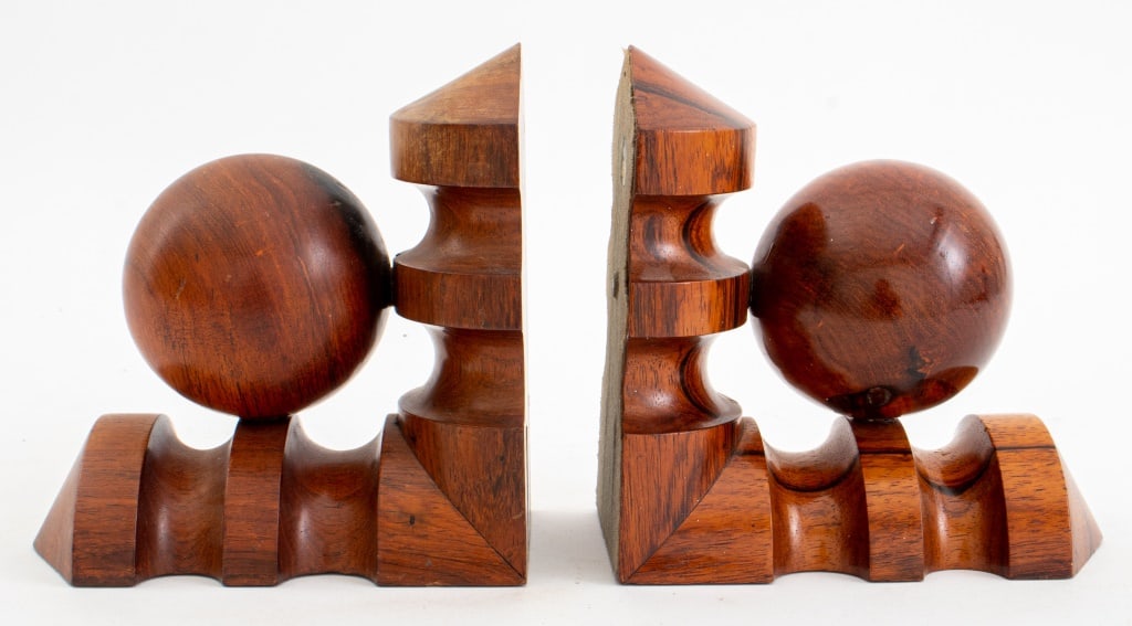 Brazilian Hardwood Geometric Bookends, Pair: Pair of Brazilian Hardwood Geometric Bookends, unmarked. 6" H x 5.75" W x 3.25" D. Provenance: From a New York City Collection. Keywords: Bookcase accessories, Sculpture, Statue, Turned wood, Decorati