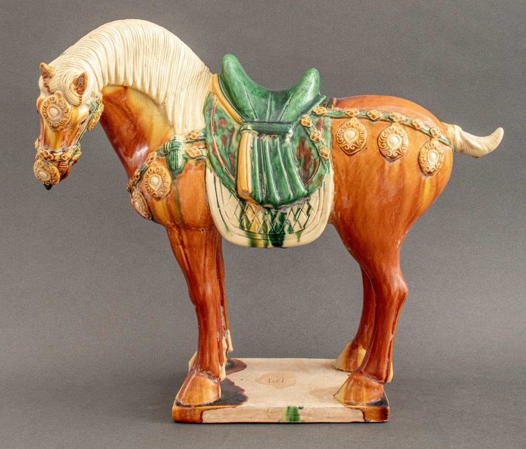 Tang Style Sancai Glazed Terracotta Horse Figure: Tang Style Sancai Glazed Terracotta Horse Figure, glazed in white, yellow and green, stamp to square plinth. 15" H x 17" L x 6" D.