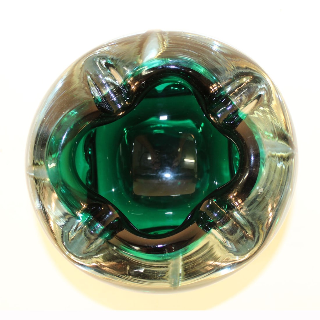 Murano Green Art Glass Pinched Bowl: Murano Green Art Glass Pinched Bowl, encased in clear glass. 4" H x 6" Diameter. Provenance: From a New York City Collection. Keywords: Studio Glass, Venetian, Vessel, Italian, Vide poche, Ashtray, Ce