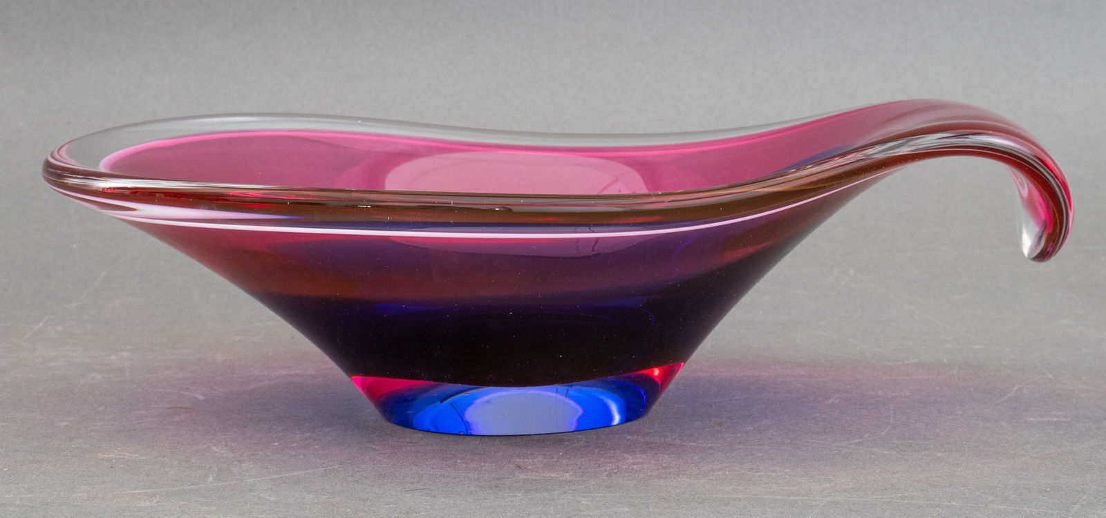 Swedish Flygsfors Coquille Bowl: Swedish Flygsfors Coquilles Glass Bowl, in rose, indigo, and colorless glass, signed to underside. 4" H x 13" L x 9" D. Provenance: From a New York City Collection. Keywords: Art Glass, Mid-Century Mo