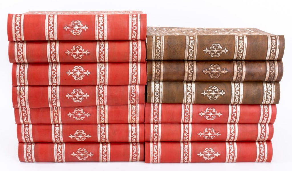 Medieval Revival Leather-Bound One Size Books, 13: Set of 13 Leather-Bound Prop Blank Books, in red and brown with tooled silver-tone Medieval Revival design. Each: 16.5" H x 11.5" W x 2.75" D. Provenance: From an Upper West Side estate located at the