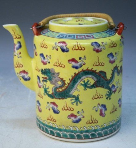 Chinese Yellow Ground Teapot with Dragons: Famille rose teapot with yellow ground and dragons, porcelain, China; marked. Dimensions: approximately 6"H x 6-3/4"W x 5" diameter