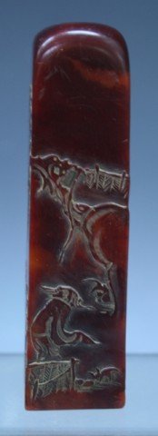 Chinese Carved Red Soapstone Seal: Carved red soapstone seal with figural landscape, China; marked. Dimensions: 3-3/4"H x 1" square