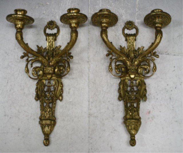 Pair of English Gilt Bronze Sconces ca. 1890s: Pair of wall sconces with ornate scrolling foliate motif and two candle wells each, gilt bronze, England, ca. 1890s; unmarked. Dimensions: each approximately 13-3/4"L x 8-1/2"W x 4"D