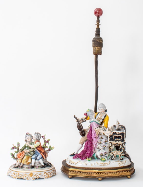 Capodimonte Porcelain Figures, 2: Group of Two Capodimonte Porcelain Figures, comprising one gallant scene with lady playing pianoforte and gentleman holding a violin mounted as a lamp and another gallant scene with seated boy and gir
