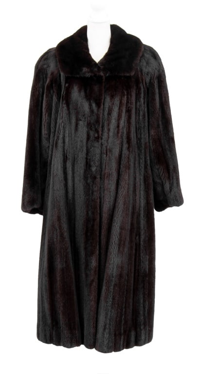 Georgeou Furs Mink Fur Coat: Georgeou Furs Mink Fur Coat, labeled "Georgeou / Westchester" to collar, with interior waist tie and interior pocket to right side. Overall: 46"; Shoulders: 19"; Sleeves: 24". Provenance: From a 50 Ce