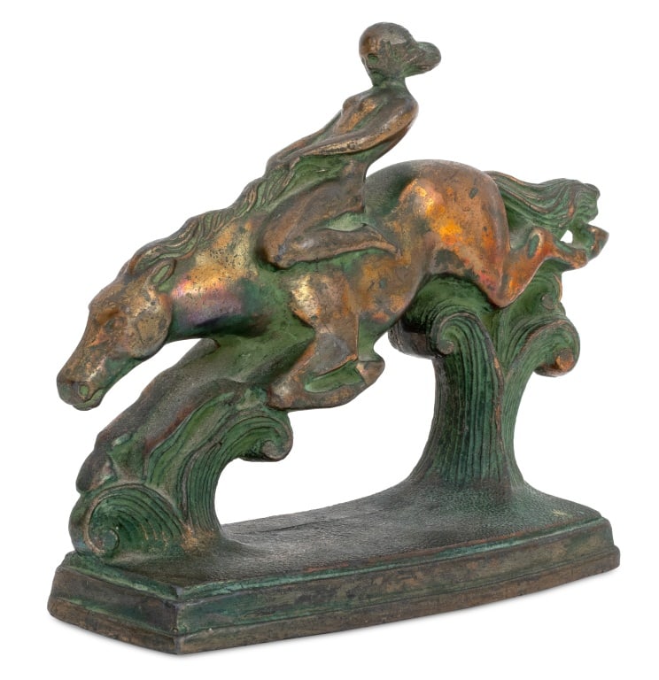 Nuart Art Nouveau Woman on Horse Patinated Bookend: Nuart Art Nouveau Woman on Horse Patinated Metal Bookend, depicting a nude female figure atop a galloping horse. 5.75" H x 7.5" W x 2.5" D. Provenance: From the Upper East Side Apartment of a Former A