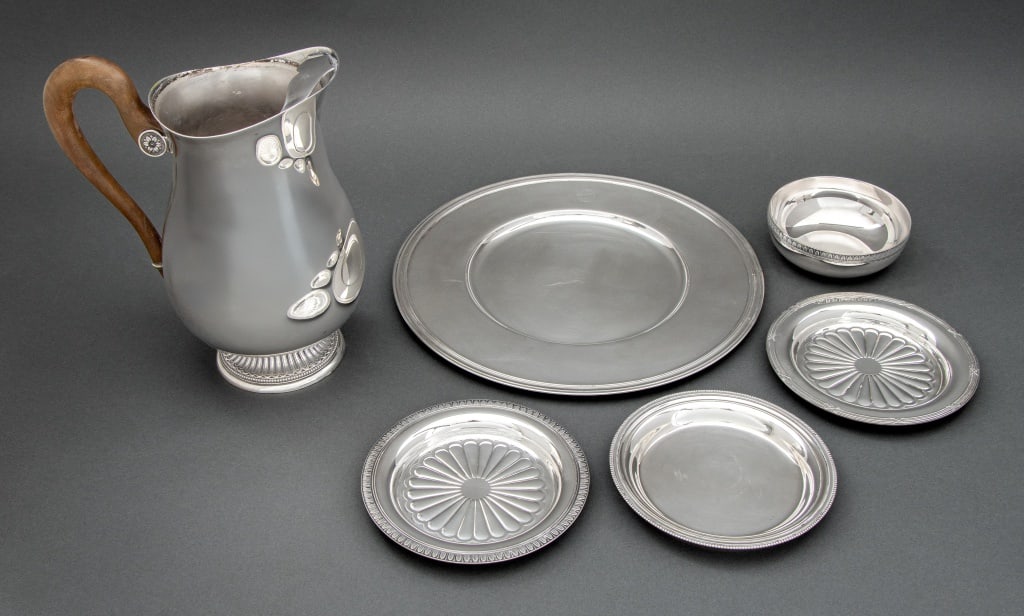 Christofle Silver Plate Tableware, 6 Pcs.: Group of Six Christofle Silver Plate Tableware Pieces, comprising: water pitcher with carved wood handle, small bowl and wine bottle coaster both in "Malmaison" pattern, wine bottle coaster in "Rubans