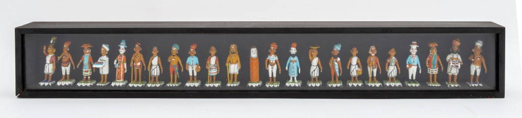 Hand-Painted Art Pottery Indian Figures, 23: Group of 23 Hand-Painted Art Pottery Indian Figures, mounted in ebonized wood shadowbox. 4.25" H x 29.5" W x 2.25" D. Provenance: From a 50 Central Park West Estate. Keywords: Statues, Ceramics, Studi