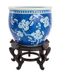 Chinese Blue & White Porcelain Prunus Jardiniere: Chinese Blue and White Glazed Porcelain Prunus Motif Jardiniere, on carved wood stand. Overall: 17.25" H x 13.5" Diameter. Provenance: From the Upper East Side Apartment of a Former Ambassador. Keywor