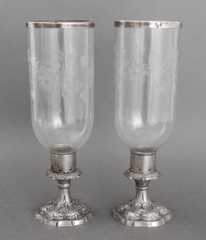 Etched Glass and Silvered Metal Hurricanes, Pair: Pair of Etched Glass and Silvered Metal Hurricanes, of typical form with etched glass shades and silvered repousse style bases. 14.5" H x 5" Diameter. Provenance: From a New York City Collection. Keyw