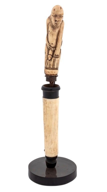Lomdok Betel Nut Bone Figural Chisel & Cylinder, 2: Lomdok Betel Nut Carved Bone Figural Chisel Knife and Cylinder, the chisel with seated nude male figure with one knee up, with horn and wood cylinder, on smoky acrylic stand. Chisel: 8.25" H x 1" W x