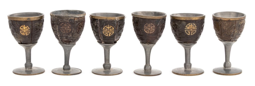 Chinese Carved Coconut and Pewter Stem Cups, 6: Set of Six Chinese Carved Coconut and Pewter Stem Cups, in wood box marked with four carved characters. Overall in fair condition, prior repairs and cracks to the coconuts. 2.75" H x 13.5" W x 4" D. P