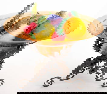 Amber Glass Bowl of Ceramic Fruit on Iron Stand: Amber Glass Bowl of Polychrome Glazed Ceramic Fruit on Wrought Iron Stand, with acanthus leaf and rose details. 10.25" H x 15.5" Diameter. Provenance: From a Manhattan Collector. Keywords: Art Glass,