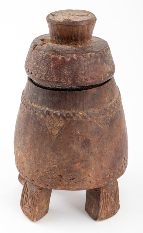 African Hand-Carved Wood Covered Jar: African Hand-Carved Wood Covered Jar, with geometric designs to vessel, lid, and four legs. 8.75" H x 4.75" Diameter. Provenance: From the collection of Le Lieu and Malcolm Browne (American, 1931-2012