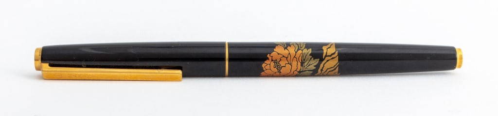 Namiki 18K Gold Nib Lacquered Fountain Pen: Namiki 18K Gold Nib Lacquered Fountain Pen, with 18K gold nib having cherry blossom flower motifs to barrel and cap. 5" H x 3/8" Diameter. Provenance: From a New York City Collection. Keywords: Design
