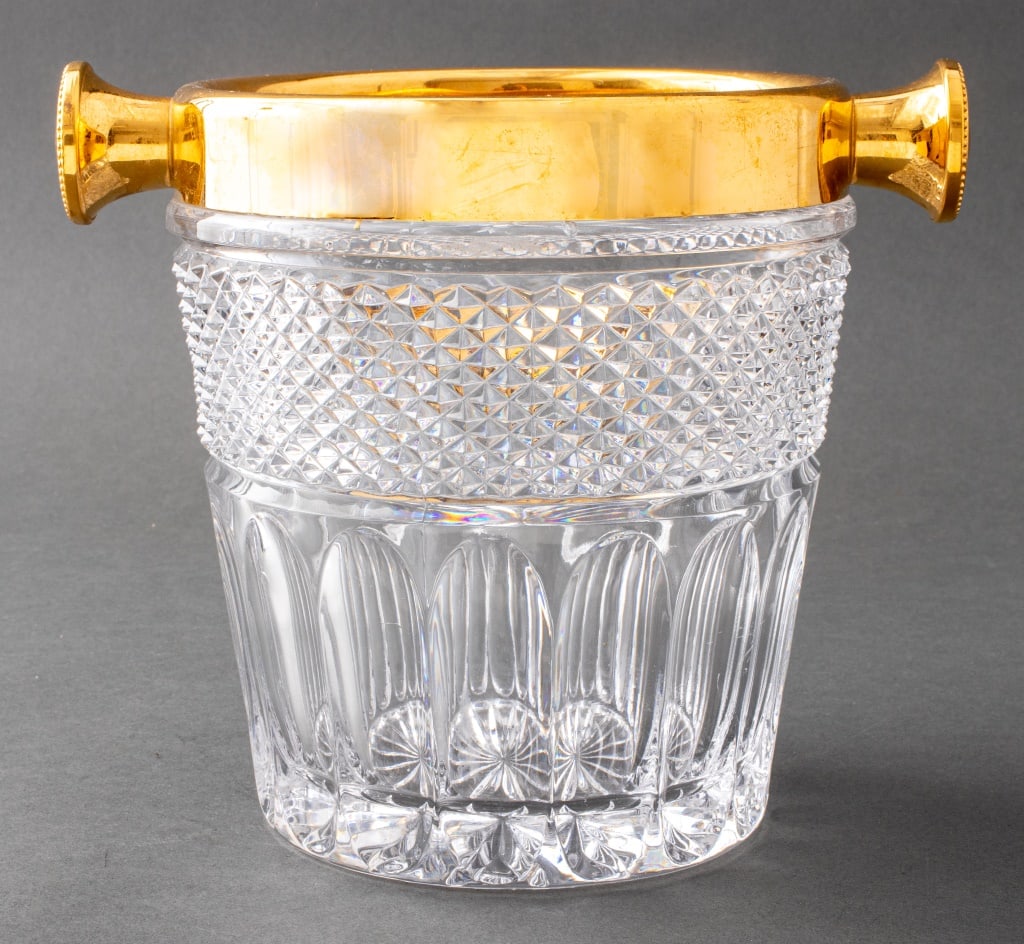 German Cut Crystal Champagne Bucket: German Cut Crystal Champagne Bucket, with a gold-toned metal rim, marked made in West Germany to rim. 8.75" H x 10" W x 7.5" D. Provenance: From a New York City Collection. Keywords: Glassworks, Glass