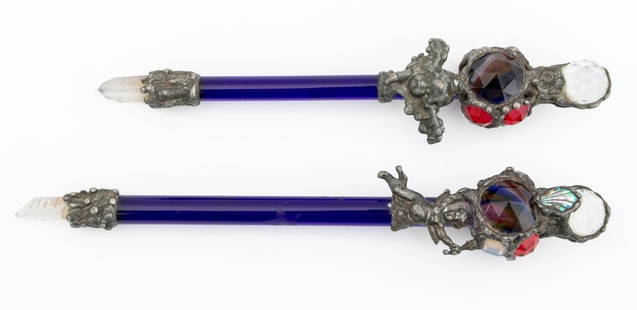 Cobalt Blue Glass & Rock Crystal Wands, 2: Two Cobalt Blue and Rock Crystal Wands, each with star motif etched stem, forged metal cherub, and polychrome glass and faceted orb form handle. Larger: 9.5" H x 1.5" W x 1.25" D. Provenance: From an