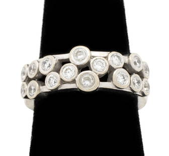 14K White Gold Diamond Band: 14K White Gold Diamond Band, featuring 16 round brilliant cut diamonds, bezel set weighing a total of approx. 0.80 carat, marked: "14K US (c)". Measuring approx. US size 7 1/2, 1/4" across widest
