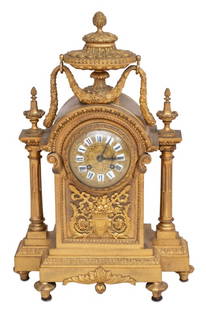 Louis XVI Style Gilt Bronze Mantel Clock: Louis XVI Style Gilt Bronze Mantel Clock, late 19th century, surmounted by an urn issuing a laurel wreath, the circular dial with enamel numerals, the movement strike on bell, flanked by tapering colu