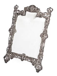 German Cast Silver Tabletop Mirror: German Cast Silver Tabletop Mirror, 19th century, in the 17th century style, the rectangular frame cast with roundels depicting various industrial pursuits, enclosing a beveled mirror plate, apparentl