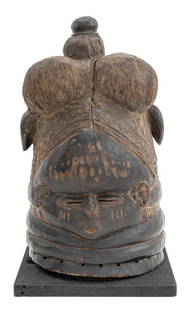 African Mende Carved Wood Helmet Mask: African Mende Carved Wood Helmet Mask, together with Segy Gallery documentation, atop a square ebonized wood base. Overall: 16" H x 9.25" W x 9.5" D. Provenance: Segy Gallery, New York. From a Fifth A